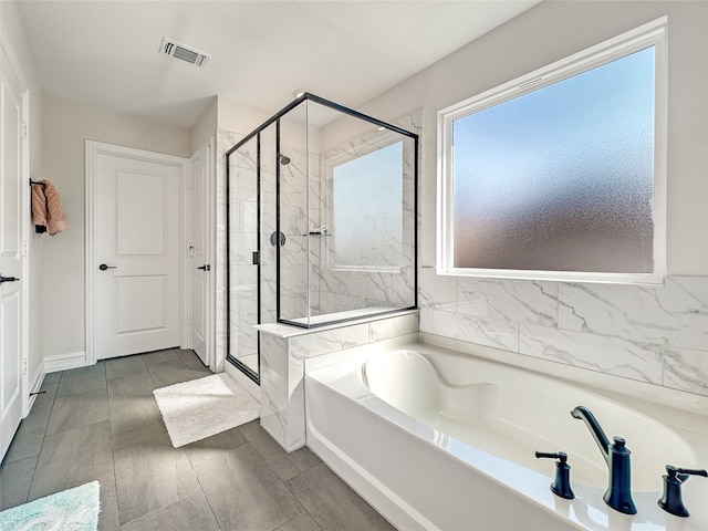 bathroom with separate shower and tub