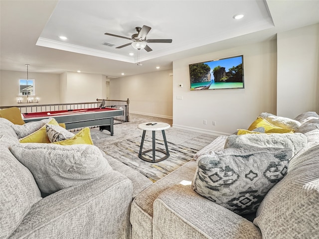 rec room featuring ceiling fan, a tray ceiling, and crown molding