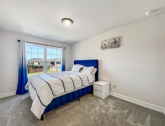 bedroom featuring a textured ceiling and carpet flooring