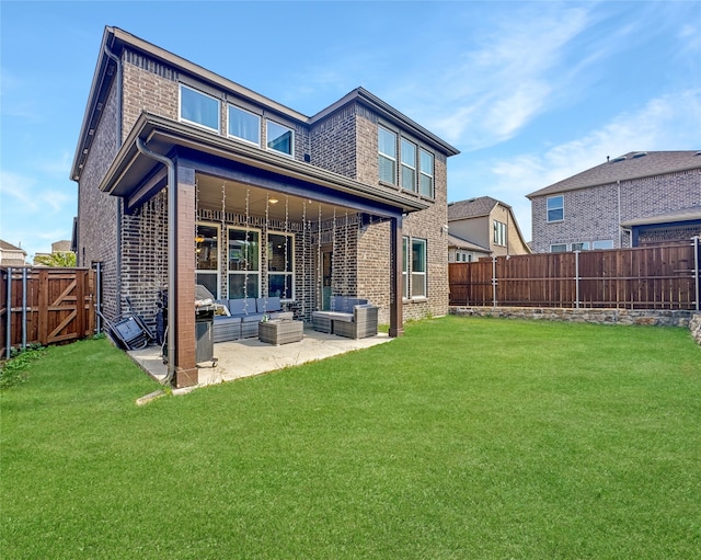 back of house with a yard, an outdoor living space, and a patio