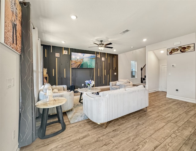 living room with ceiling fan and light hardwood / wood-style floors