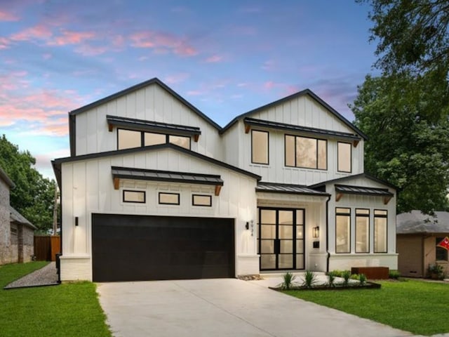 modern inspired farmhouse with a lawn