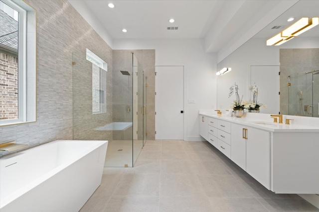 bathroom with vanity, shower with separate bathtub, and tile patterned flooring