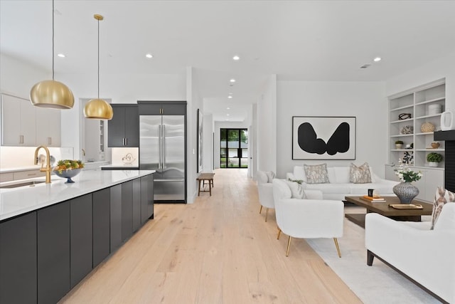 living room featuring sink and light hardwood / wood-style floors