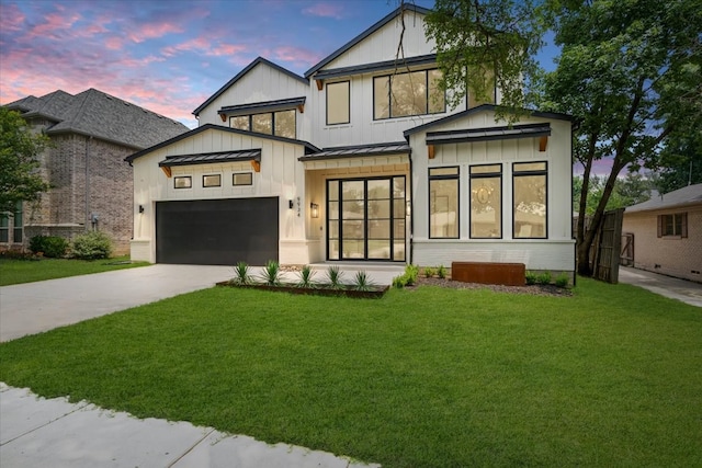 view of front facade featuring a garage and a lawn