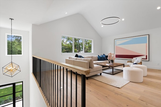 living room featuring an inviting chandelier, hardwood / wood-style flooring, and a wealth of natural light