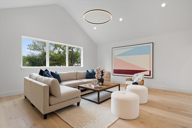 living room featuring light hardwood / wood-style floors and high vaulted ceiling