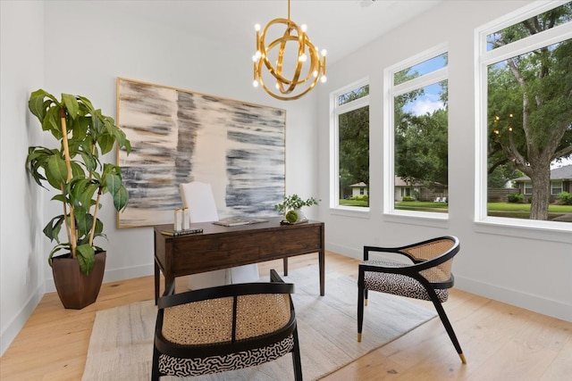 office space with light hardwood / wood-style floors, a notable chandelier, and a wealth of natural light