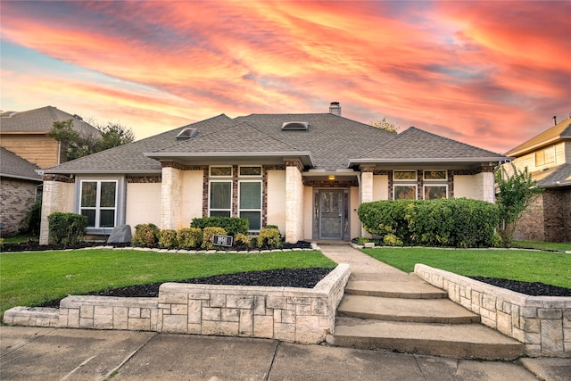 prairie-style home featuring a lawn