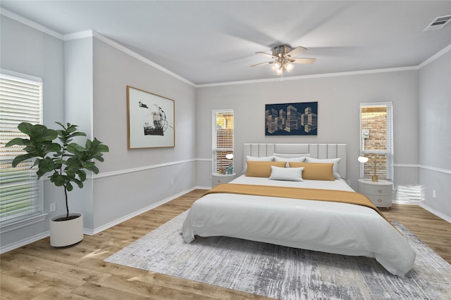 bedroom with light hardwood / wood-style flooring, multiple windows, and ceiling fan