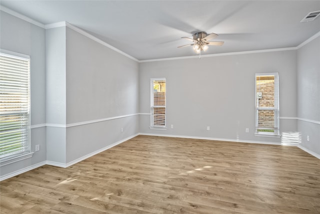 spare room featuring ornamental molding and light wood-type flooring