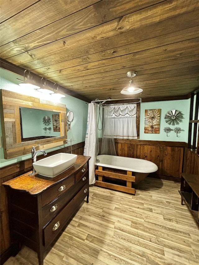 bathroom with vanity, hardwood / wood-style flooring, wooden walls, and wooden ceiling