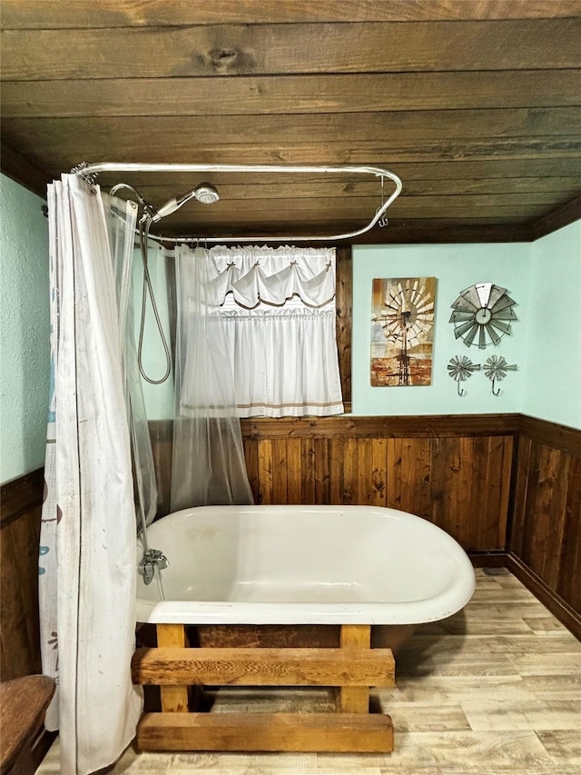 bathroom featuring wood walls and wood-type flooring