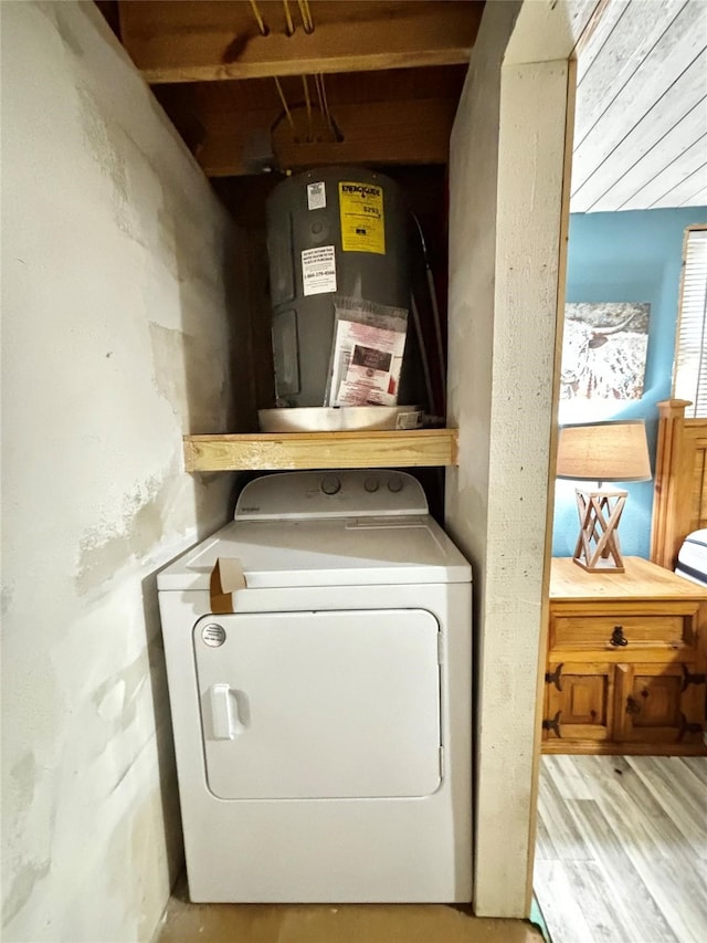 washroom with electric water heater, washer / clothes dryer, and light hardwood / wood-style flooring