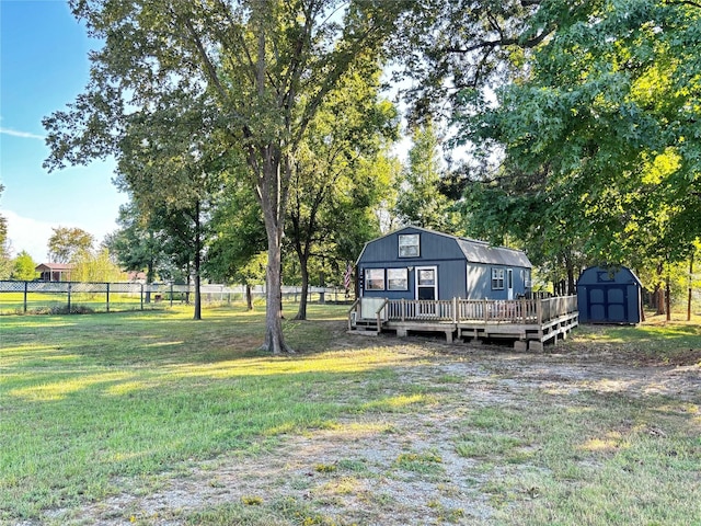 view of yard with a storage unit and a deck