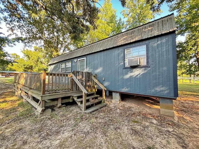 back of property with cooling unit and a wooden deck