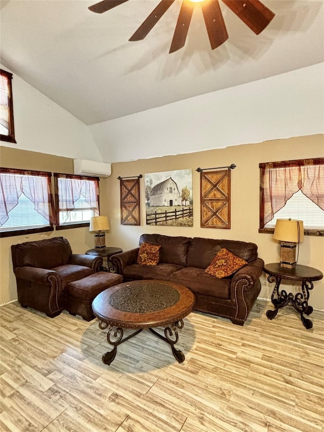 living room featuring ceiling fan, light wood-type flooring, lofted ceiling, and a wall mounted AC