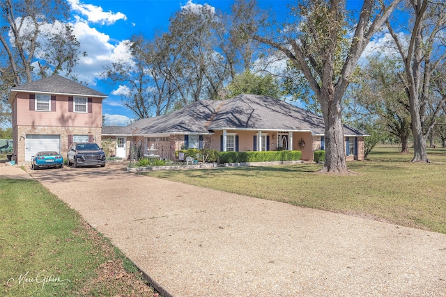 view of front of property with a garage and a front lawn