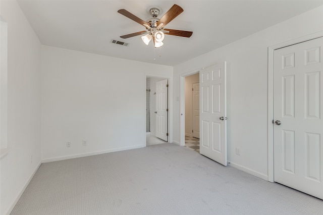 unfurnished bedroom featuring ceiling fan and light carpet