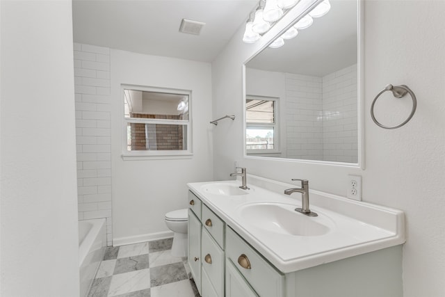 full bathroom featuring vanity, tiled shower / bath combo, and toilet