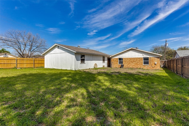 rear view of house with a yard