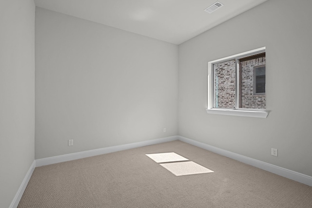 spare room featuring visible vents, baseboards, and carpet