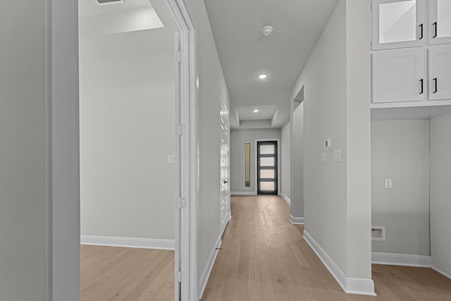 hallway with recessed lighting, light wood-type flooring, and baseboards