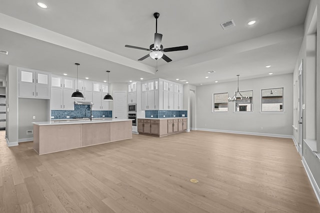 kitchen featuring visible vents, ceiling fan, light wood-type flooring, appliances with stainless steel finishes, and a sink