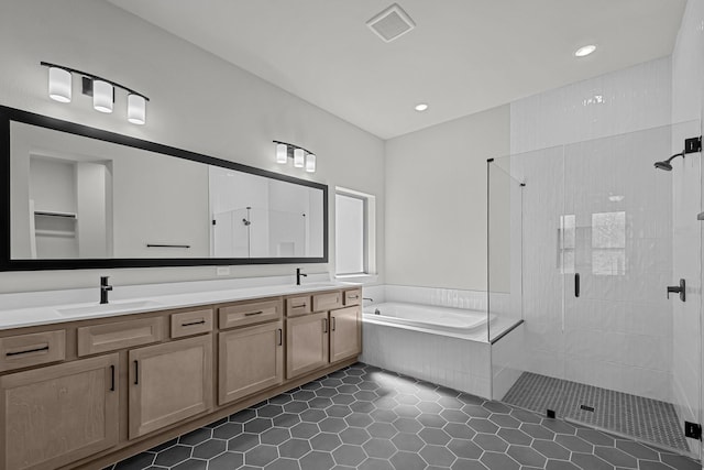 bathroom with a sink, double vanity, a bath, and a shower stall