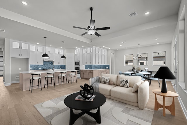 living area featuring recessed lighting, visible vents, light wood-style floors, and ceiling fan