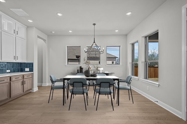 dining space featuring recessed lighting, baseboards, and light wood finished floors