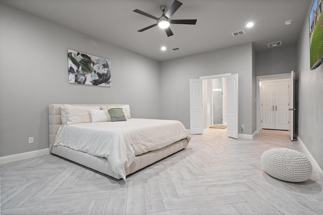 bedroom with ceiling fan, connected bathroom, and light parquet floors