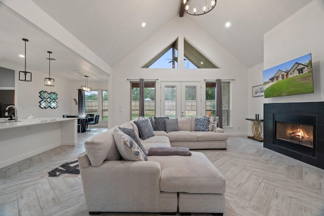 living room featuring high vaulted ceiling, a wealth of natural light, light parquet floors, and a tile fireplace