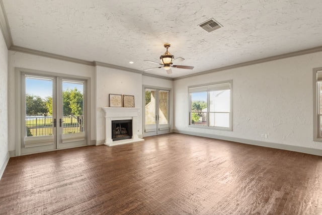 unfurnished living room featuring plenty of natural light, hardwood / wood-style flooring, and ceiling fan