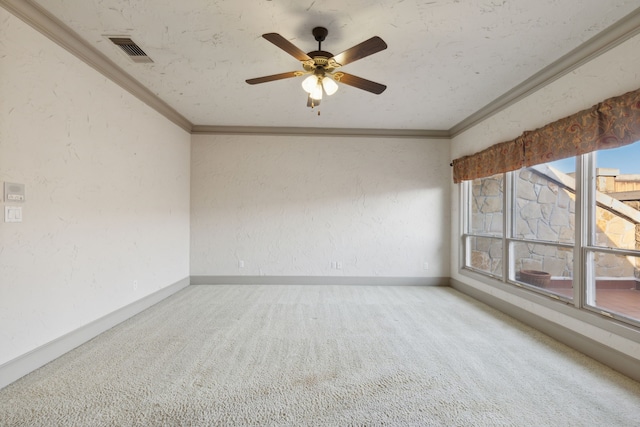 empty room with crown molding, carpet, and ceiling fan