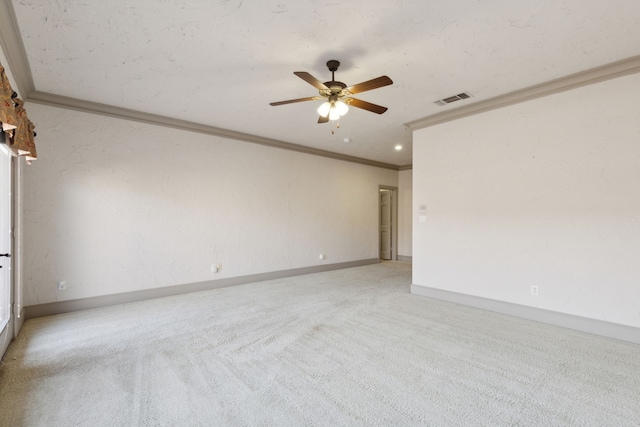 unfurnished room with ornamental molding, light colored carpet, and ceiling fan