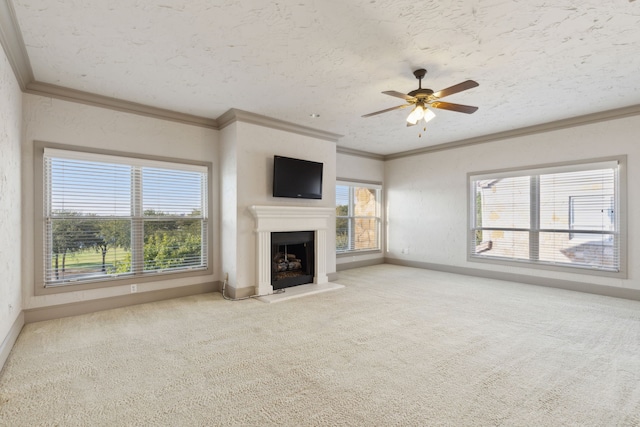 unfurnished living room with carpet floors, a textured ceiling, crown molding, and ceiling fan