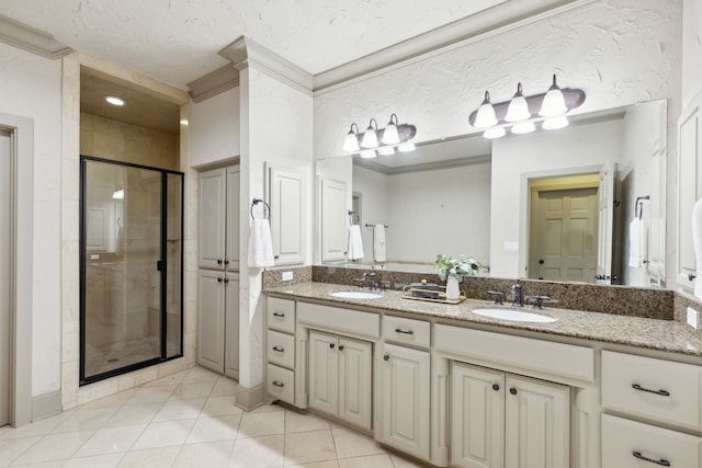 bathroom with walk in shower, vanity, crown molding, and tile patterned floors