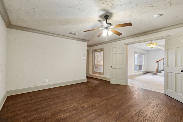 spare room with ornamental molding, hardwood / wood-style floors, a wealth of natural light, and ceiling fan