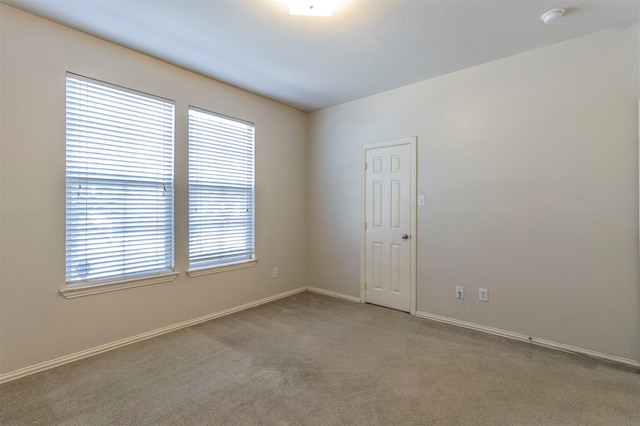 unfurnished room featuring carpet flooring and a healthy amount of sunlight