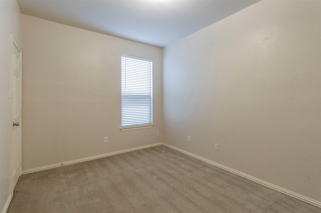 unfurnished room with light carpet