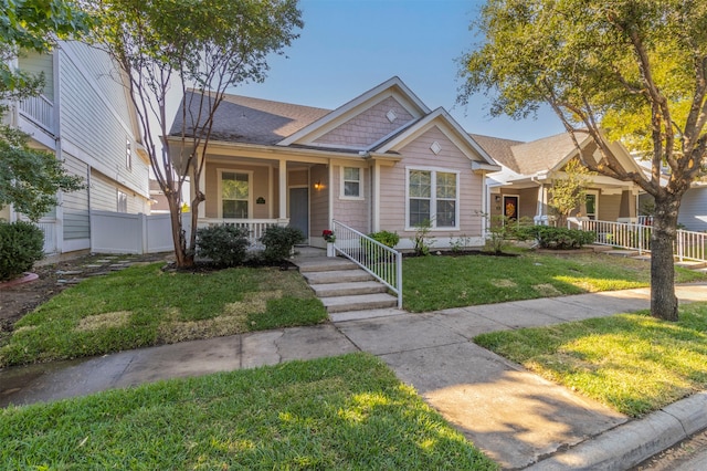 view of front facade featuring a front lawn and covered porch