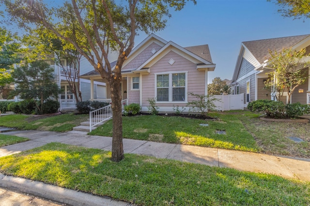 bungalow-style house with a front lawn and covered porch