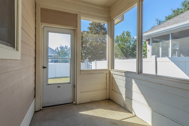 unfurnished sunroom featuring a healthy amount of sunlight