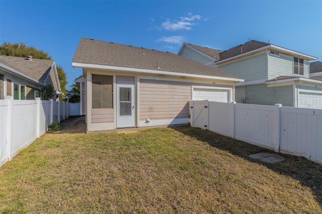 rear view of house featuring a yard