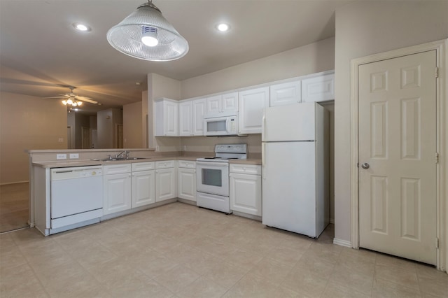 kitchen with sink, white cabinetry, white appliances, and decorative light fixtures