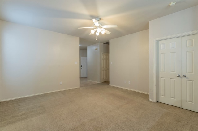 carpeted empty room featuring ceiling fan