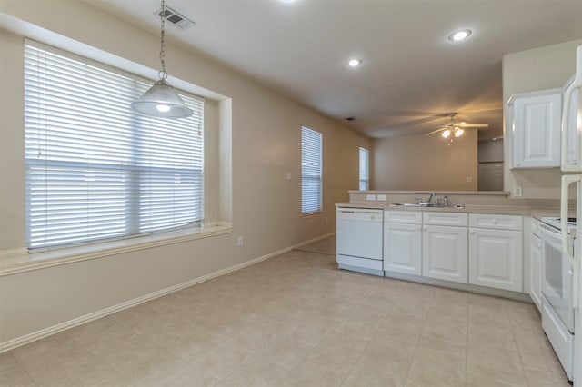 kitchen with ceiling fan, pendant lighting, white appliances, kitchen peninsula, and white cabinets