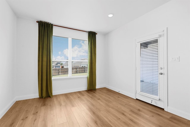 unfurnished room with light hardwood / wood-style flooring