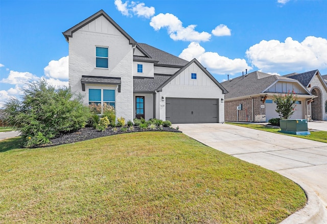 view of front of property featuring a front yard and a garage